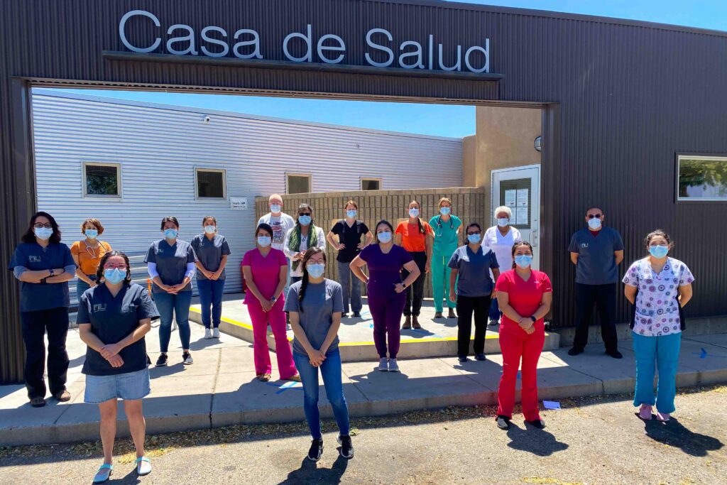 Photo of employees wearing masks outside of the Casa de Salud clinic in New Mexico